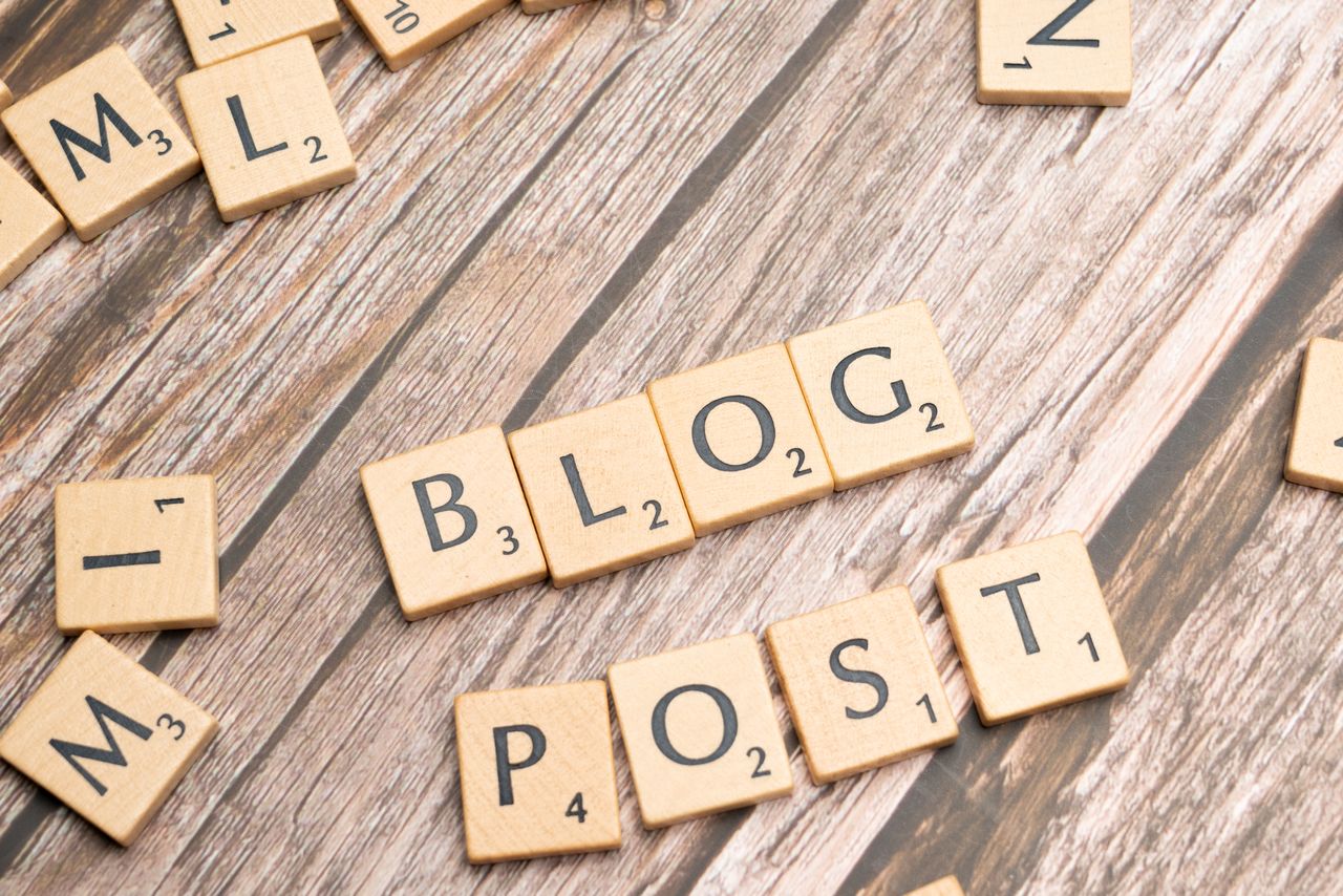 digital Wooden letter tiles spelling Blog Post on a wooden background, ideal for online media concepts.